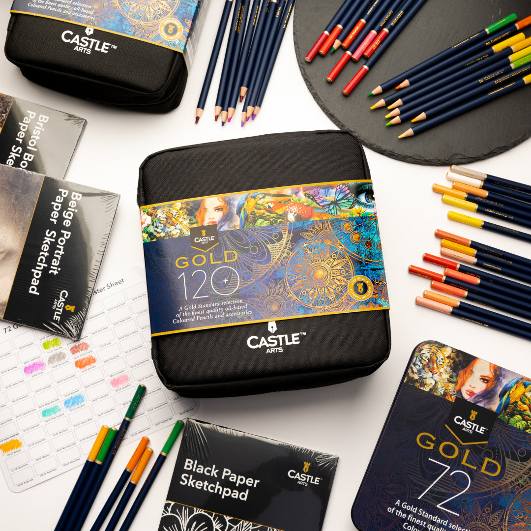 Castle Gold zip-case pencil set surrounded by Castle Gold coloured pencils, sketch pads and a Castle Gold display tin.